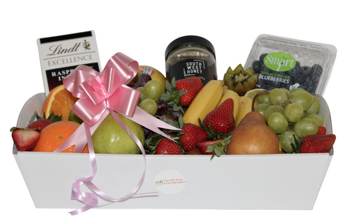 New Baby Gift - basket with fresh fruit, Lindt Chocolate and South West Honey. Choice of colour ribbons, pink blue or gold.